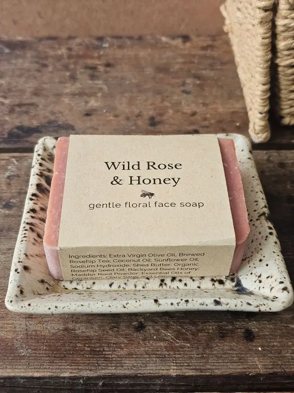 Wild Rose and Honey gentle floral face soap on ceramic dish