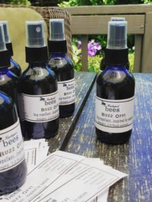 buzz off Blue spray bottles of Buzz Off natural mosquito repellent lined up