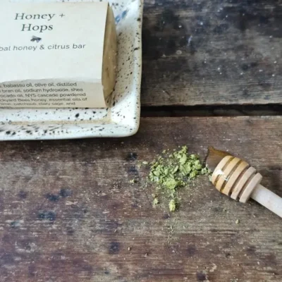 a honey soap with ground hops, Honey & Hops on a soap dish with ingredients