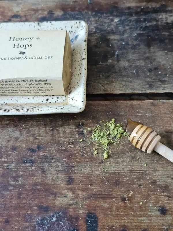 a honey soap with ground hops, Honey & Hops on a soap dish with ingredients