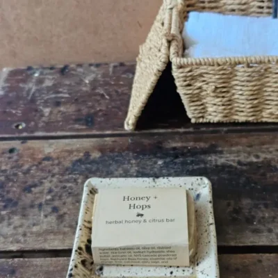 Honey & Hops styled on rustic table with soft bath cloths