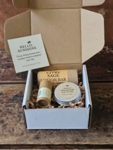 Open Sunshine Skin Care Set with lotion bar, lip balm and honey lip scrub nestled in kraft shred