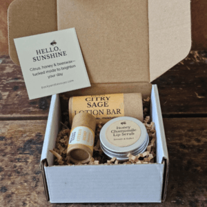 Open Sunshine Skin Care Set with lotion bar, lip balm and honey lip scrub nestled in kraft shred