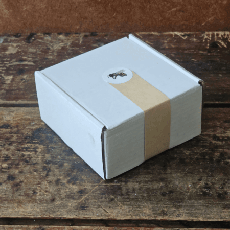 Closed Sunshine Skin Care Set gift box with kraft paper seal and bee sticker