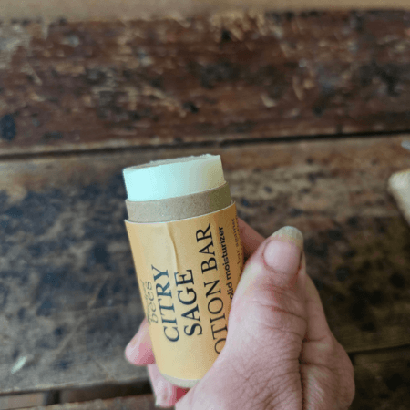 Citry Sage solid lotion bar held in hand