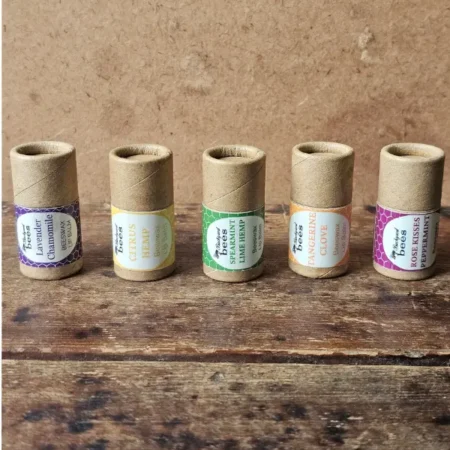 Five Backyard Bees chunky beeswax lip balms in paper tubes: Lavender Chamomile, Citrus Hemp, Spearmint Lime Hemp, Tangerine Clove and Rose Kisses Peppermint.