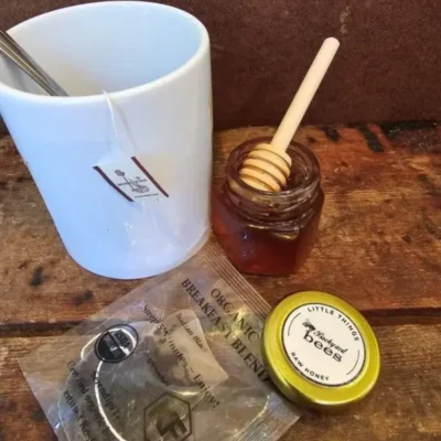 SerendipiTea sachet beside a cozy mug for relaxing self-care.