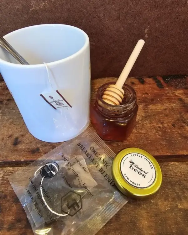 SerendipiTea sachet beside a cozy mug for relaxing self-care.