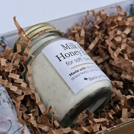 Close-up of handcrafted Milk & Honey Bath soak with natural ingredients for soft, calm skin.