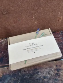 A gift-ready Milk, Honey & Lavender Bath Ritual set wrapped in a kraft belly band, styled simply for a soft, calm, natural look.