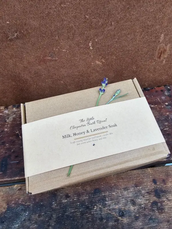 A gift-ready Milk, Honey & Lavender Bath Ritual set wrapped in a kraft belly band, styled simply for a soft, calm, natural look.