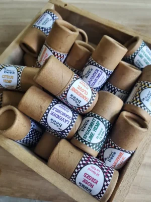 wooden tray of mixed beeswax lip balms