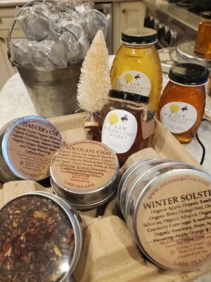 3 different size jars of honey displayed with tea options for tea and honey bag