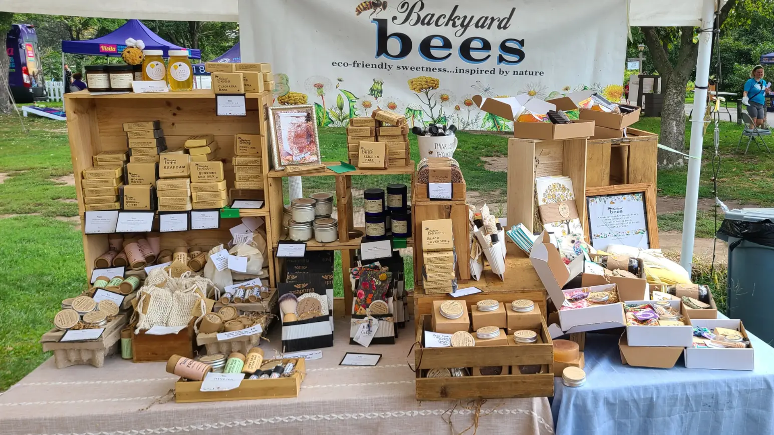 hero-shop colorful farmers market shop display of Backyard Bees natural sustainable skin care products