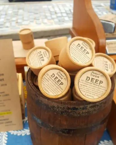 tabletop wooden barrel full of beard balms