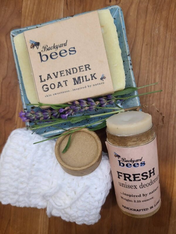 a bar of soap on a plate with lavender flowers and soft white cotton washcloth and fresh deodorant