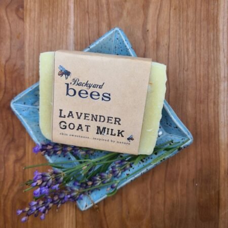 Lavender goat milk soap on ceramic farmhouse blue soap dish, with fresh spring of lavender