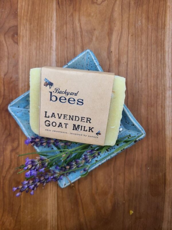 Lavender goat milk soap on ceramic farmhouse blue soap dish, with fresh spring of lavender