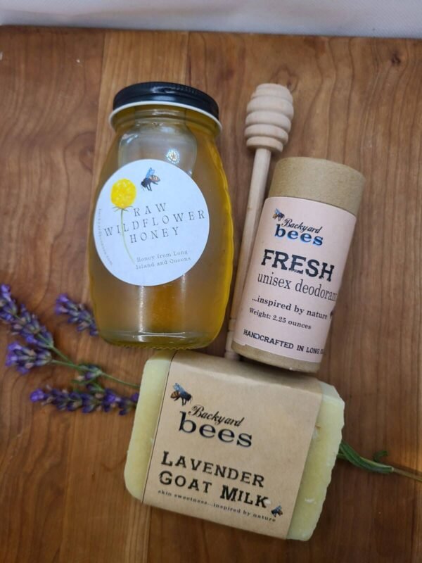 Jar of raw honey with dipper, natural deodorant, lavender soap and fresh lavender on wooden background