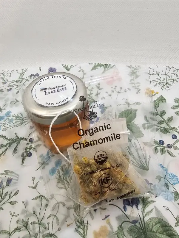 Pink-Tea-Honey close up of raw honey and Serendiptea organic chamomile tea bag