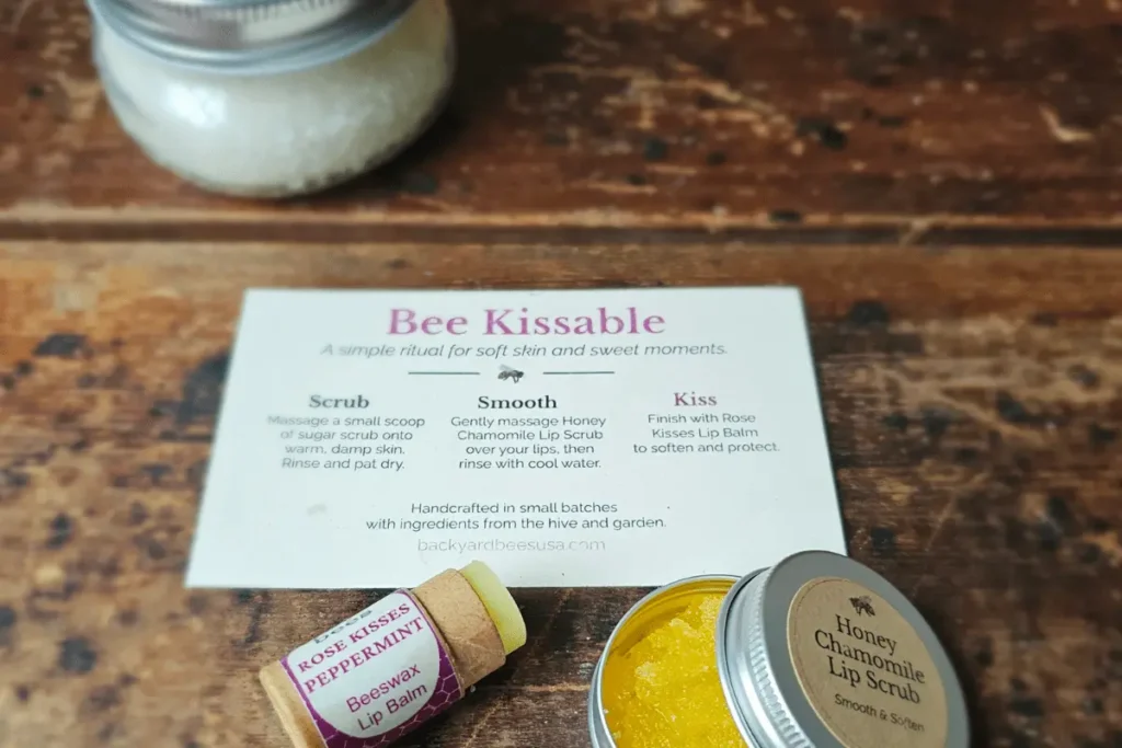 Close up of Bee Kissable Gift Box with Honey Chamomile Lip Scrub, Rose Kisses Lip Balm and ritual card