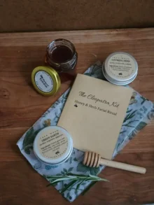 The Cleopatra Honey Facial Kit gift set with honey, two face masks, booklet, and rosemary.