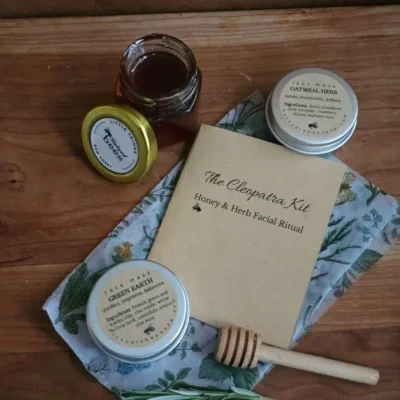 The Cleopatra Honey Facial Kit gift set with honey, two face masks, booklet, and rosemary.
