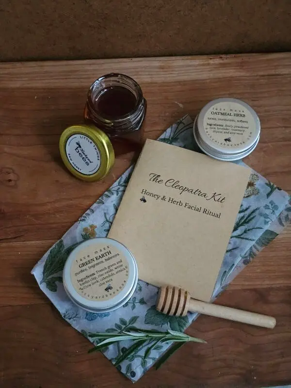 The Cleopatra Honey Facial Kit gift set with honey, two face masks, booklet, and rosemary.