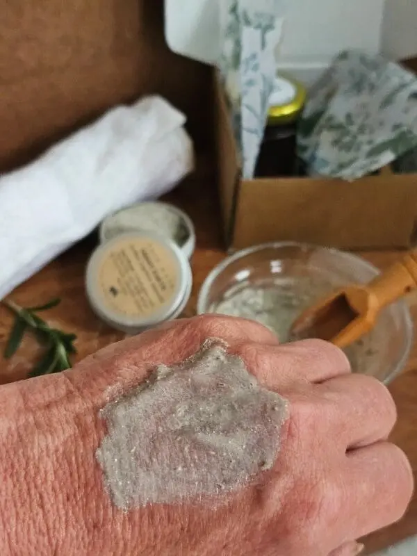 Close-up texture of the natural herbal face mask applied to skin.