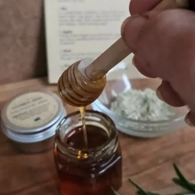 Drizzling raw honey included in The Cleopatra Kit for nourishing facial treatment