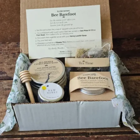 Open Bee Barefoot gift box with foot soak, Honey Loofah Soap, foot balm, raw honey, tea, and ritual card