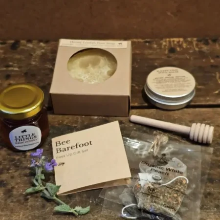 flat lay of bee barefoot everyday gift set on rustic wood table