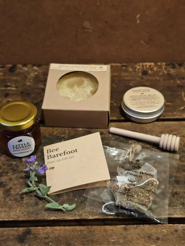 flat lay of bee barefoot everyday gift set on rustic wood table