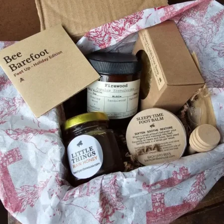 Bee-Barefoot-Holiday bee barefoot holiday edition recycled box with vintage red tissue paper filled with natural foot care treats