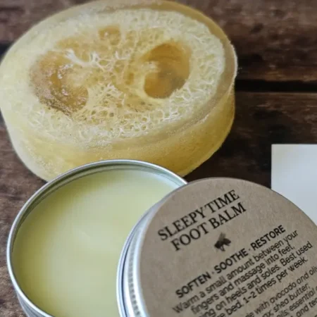 Honey Loofah Soap beside an open tin of Sleepy Time Foot Balm