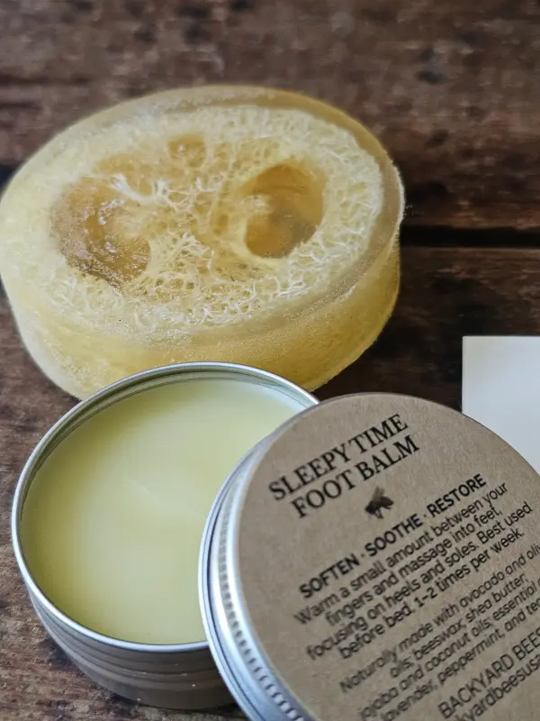 Honey Loofah Soap beside an open tin of Sleepy Time Foot Balm