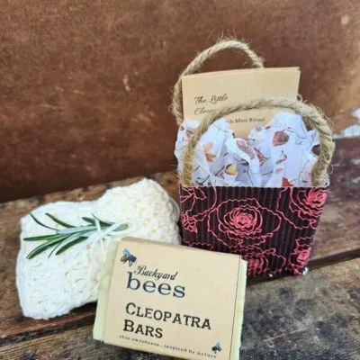 The Little Cleopatra Facial kit styled with Cleopatra Bar of goats milk soap and handmade cream cotton washcloth with sprig of rosemary