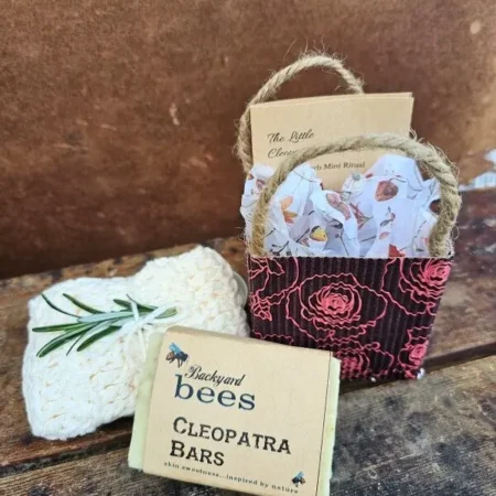 The Little Cleopatra Facial kit styled with Cleopatra Bar of goats milk soap and handmade cream cotton washcloth with sprig of rosemary
