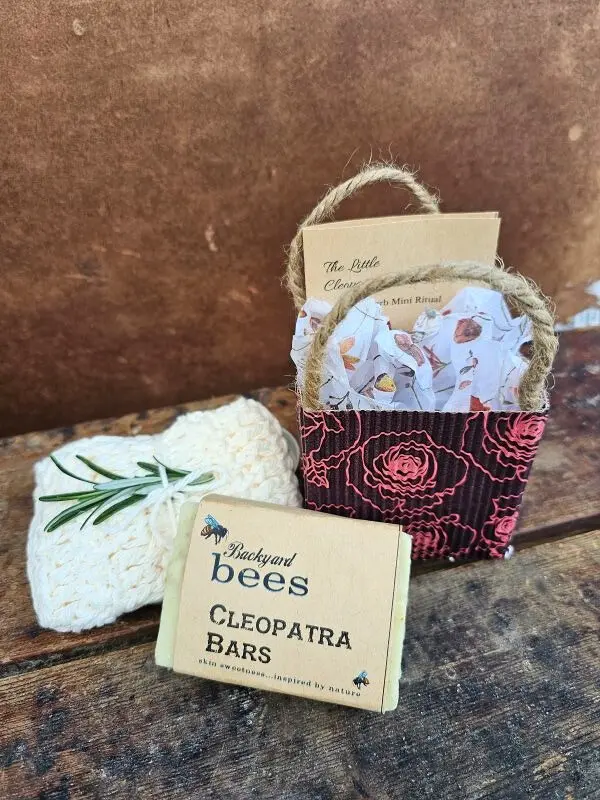 The Little Cleopatra Facial kit styled with Cleopatra Bar of goats milk soap and handmade cream cotton washcloth with sprig of rosemary