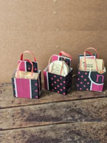 Trio of Sweet Little Things I Love You Gift Bags in handmade packaging on rustic wood table