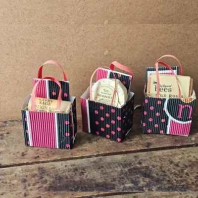 Trio of Sweet Little Things I Love You Gift Bags in handmade packaging on rustic wood table