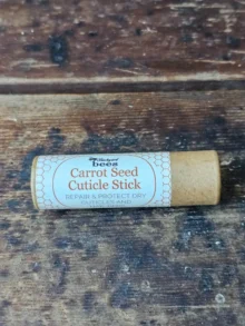 Carrot Seed Cuticle Stick by Backyard Bees on rustic wooden surface