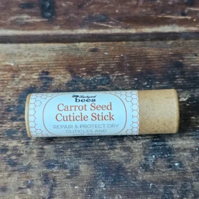 Carrot Seed Cuticle Stick by Backyard Bees on rustic wooden surface