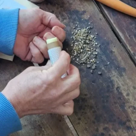 Applying Carrot Seed Cuticle Stick to dry hands after gardening