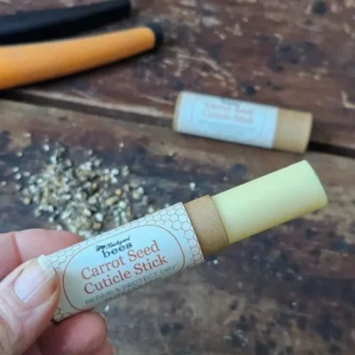 Carrot Seed Cuticle Stick extended to show solid balm and kraft tube packaging