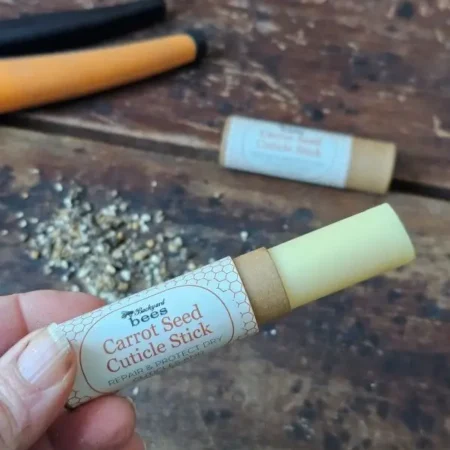 Carrot Seed Cuticle Stick extended to show solid balm and kraft tube packaging