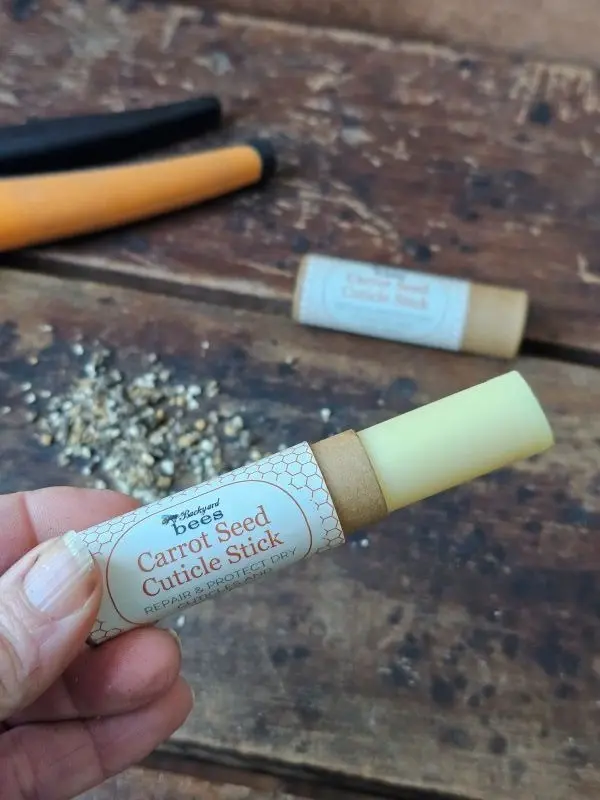Carrot Seed Cuticle Stick extended to show solid balm and kraft tube packaging
