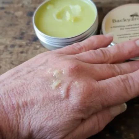 Backyard Balm Salve In Use Backyard Balm calendula comfrey salve applied to dry hardworking hands