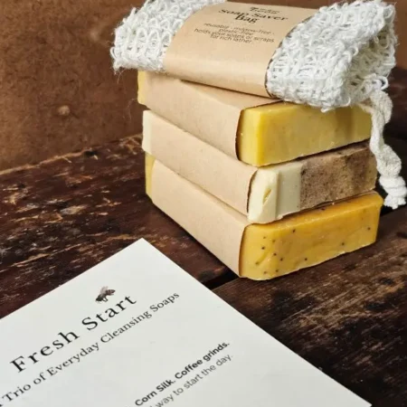 Stacked natural cleansing soap bars with reusable sisal soap saver bag