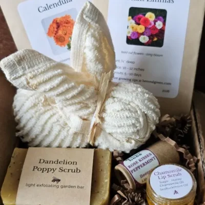 Close-up of Spring Pollinator Basket showing cotton washcloth bunny, pollinator seed packets, and botanical scrub soap.